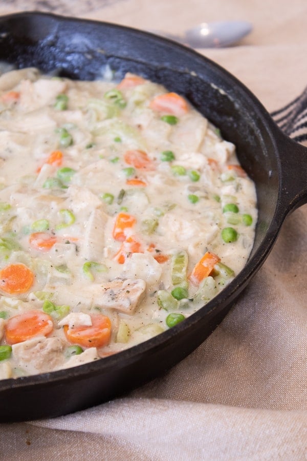 chicken pot pie mixture in a cast iron skillet before adding crust