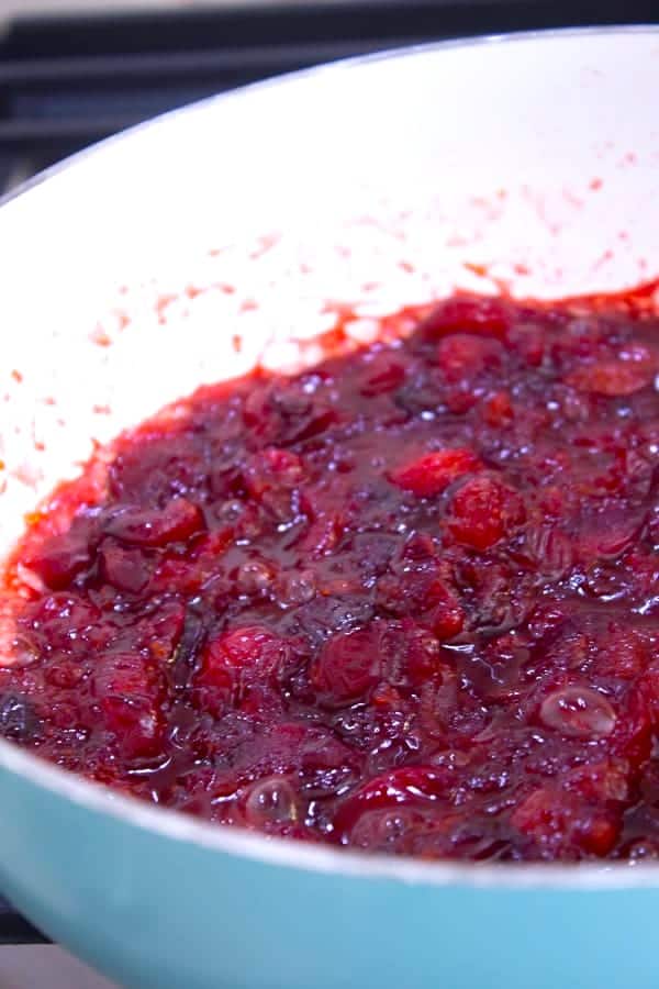 cooked cranberries in white sauce pan