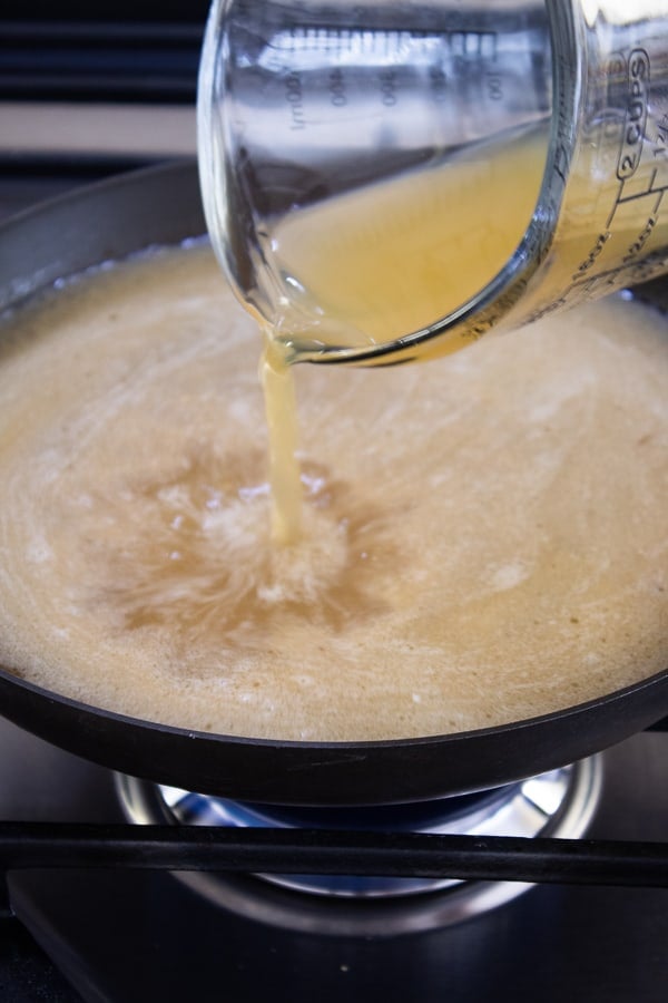 a pan with apple cider glaze being poured into it