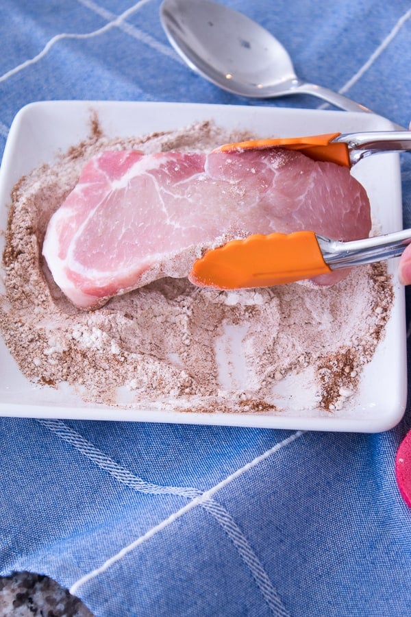 Coating pork chops in cinnamon and flour