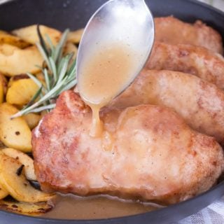 Cinnamon Crusted Pork Chops in a Black Pan with Sautéed Apples and Cider Glaze