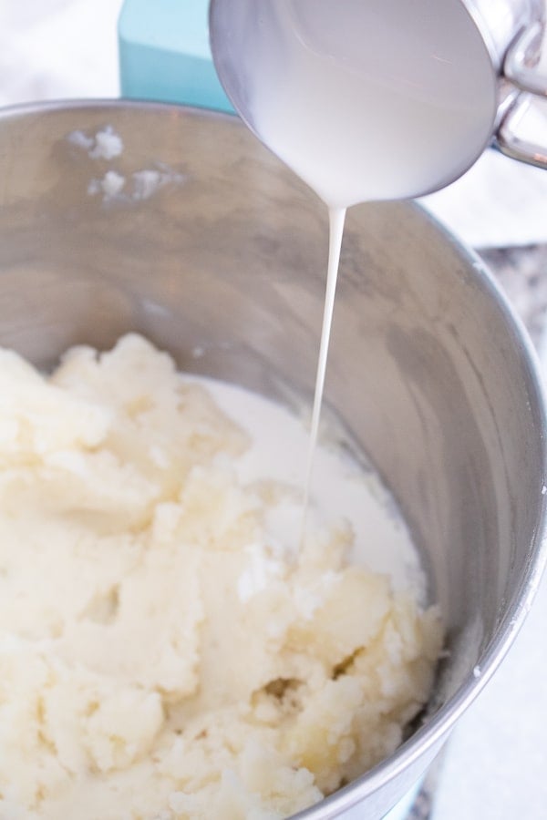 adding cream to mashed potatoes in kitchen aid mixer