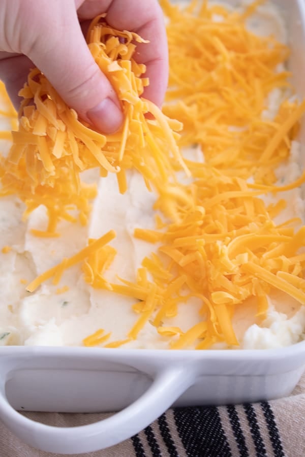adding cheese to mashed potato casserole