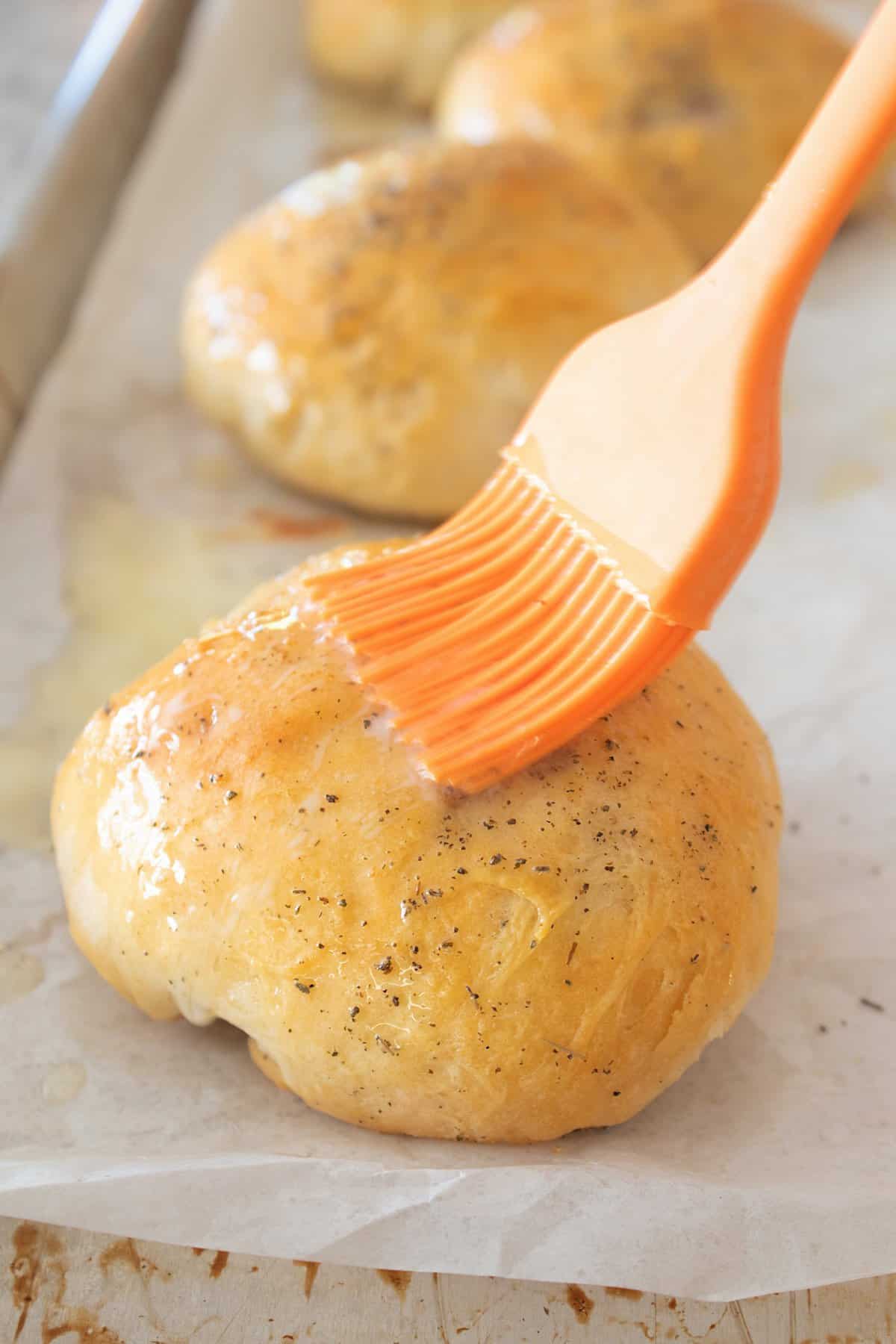 brushing stuffed biscuit with butter