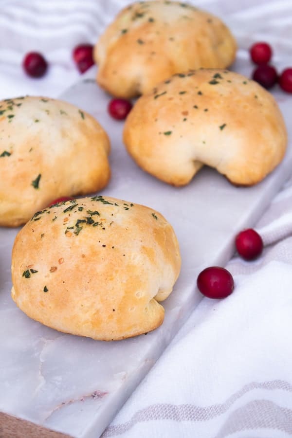 cranberry and brie filled biscuit out of the oven on a cutting board