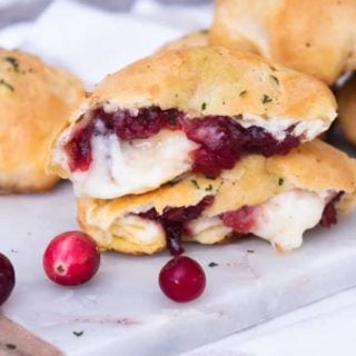 2 brie cranberry stuffed biscuits in half with gooey brie cheese