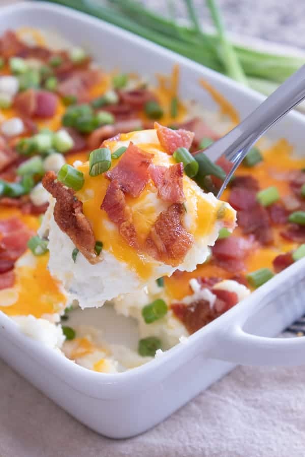 loaded mashed potato casserole in a white dish