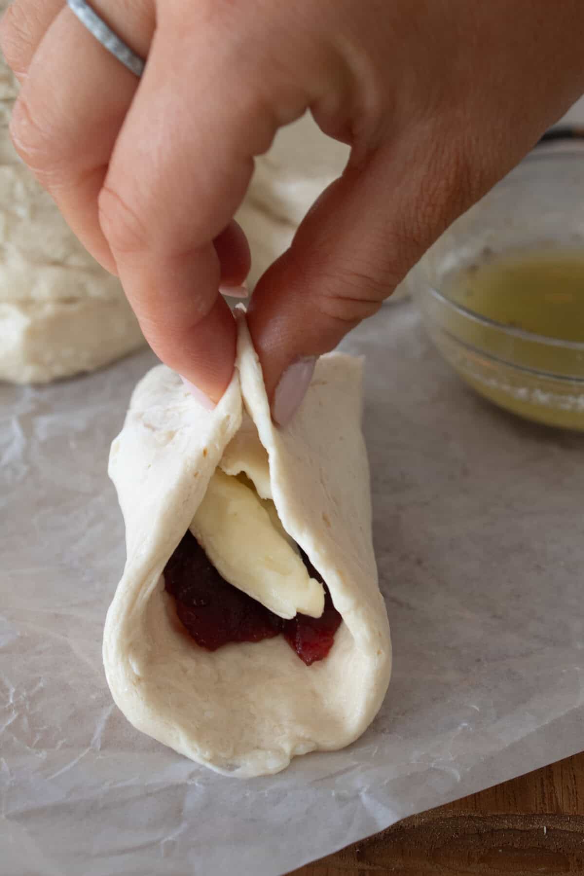 stuffing canned biscuit with brie and cranberry sauce