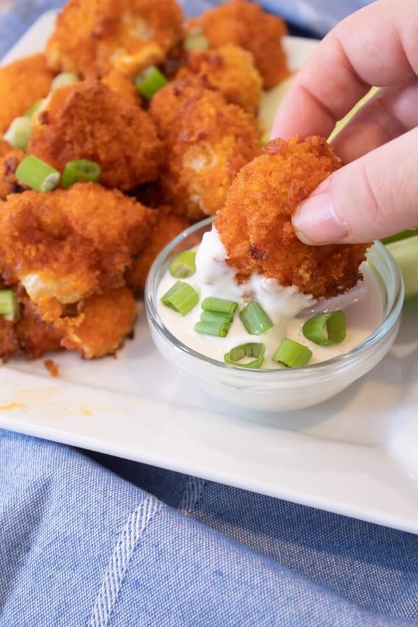 dipping cauliflower in blue cheese