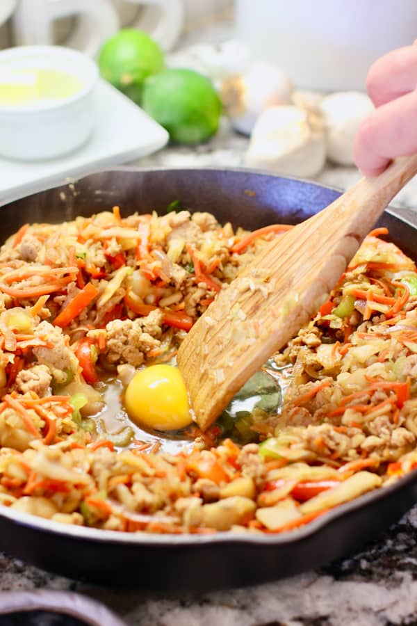 cracked egg in skillet for egg roll in a bowl