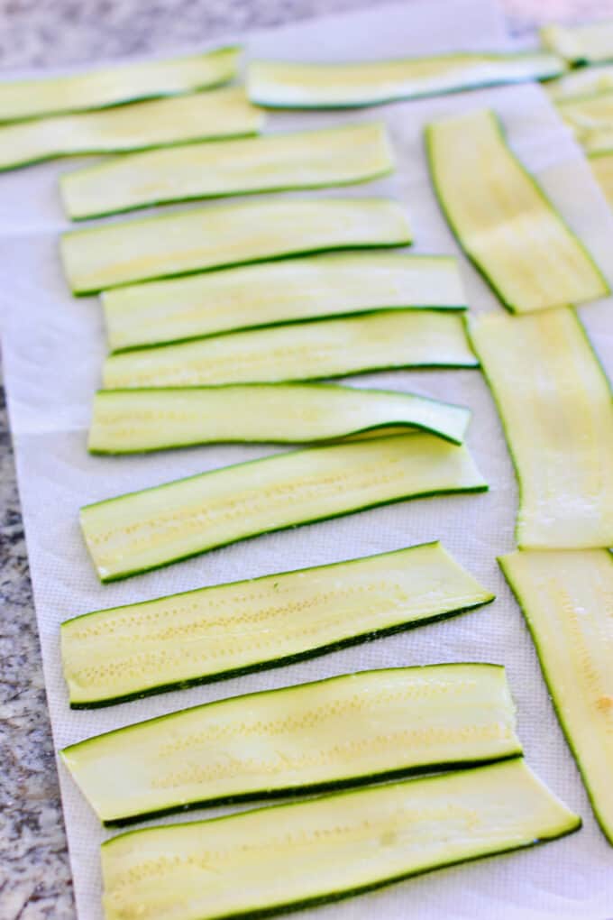 sliced zucchini on paper towels to drain
