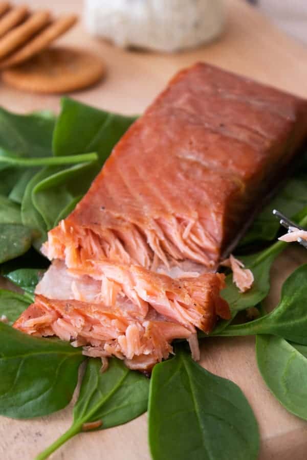 Smoked Salmon on a bed of spinach with a chunk cut out