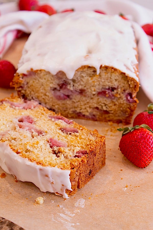 Strawberry Bread Loaf with Icing on parchment paper