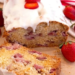 strawberry bread with icing and strawberry slices on top