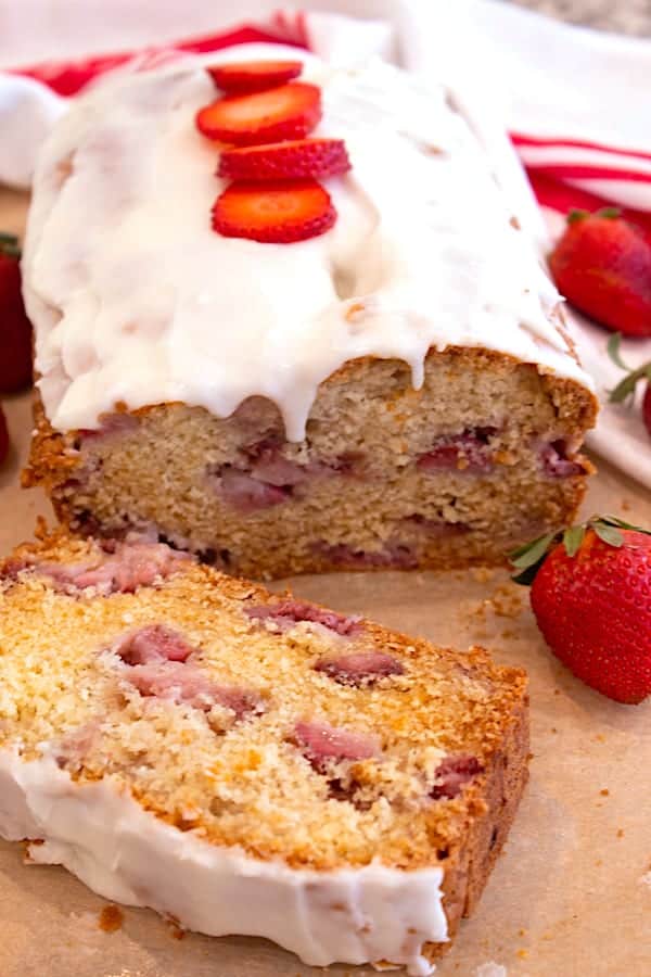 strawberry bread with icing and strawberry slices on top