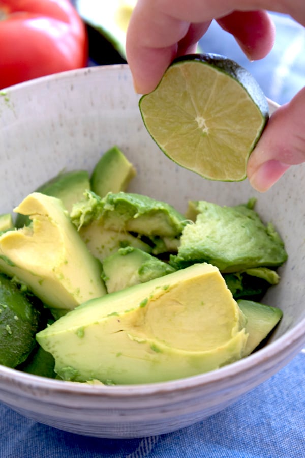 squeezing lime into guacamole