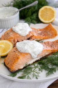 salmon and dill sauce on white platter