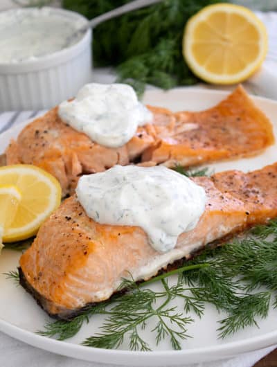 salmon and dill sauce on white platter