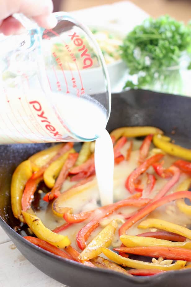 add chicken stock and wine to cooked peppers