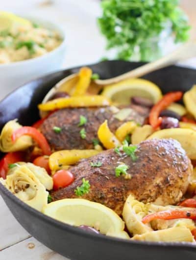 chicken and Mediterranean spices and veggies in a skillet