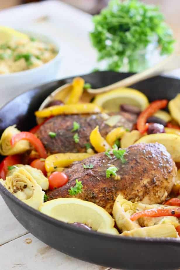 chicken and Mediterranean spices and veggies in a skillet