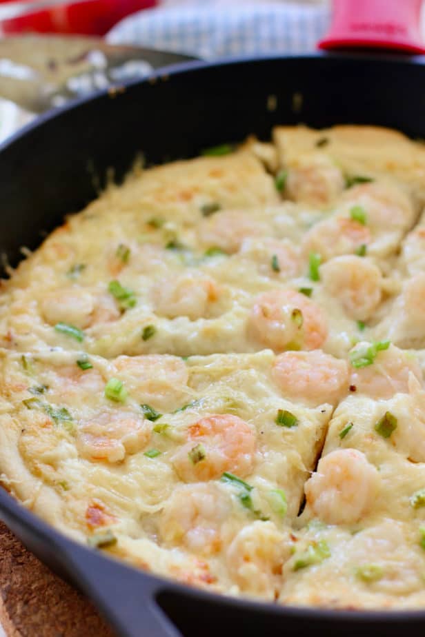 shrimp alfredo pizza in a cast iron pan