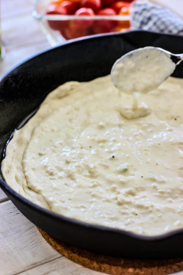 spread the alfredo sauce onto the uncooked pizza dough