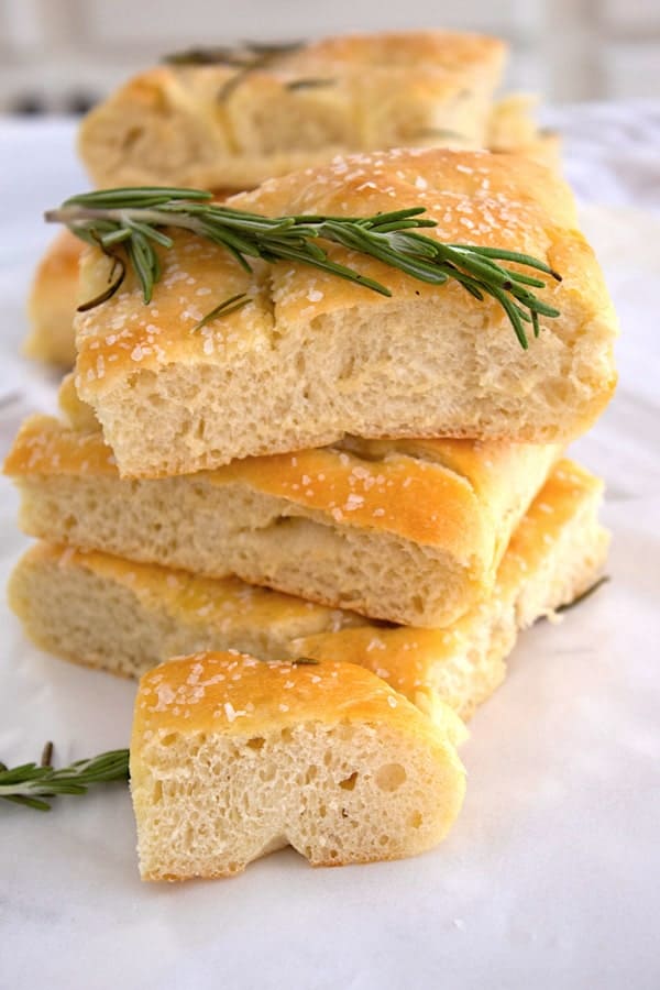 stacked focaccia bread with rosemary sprigs and sea salt