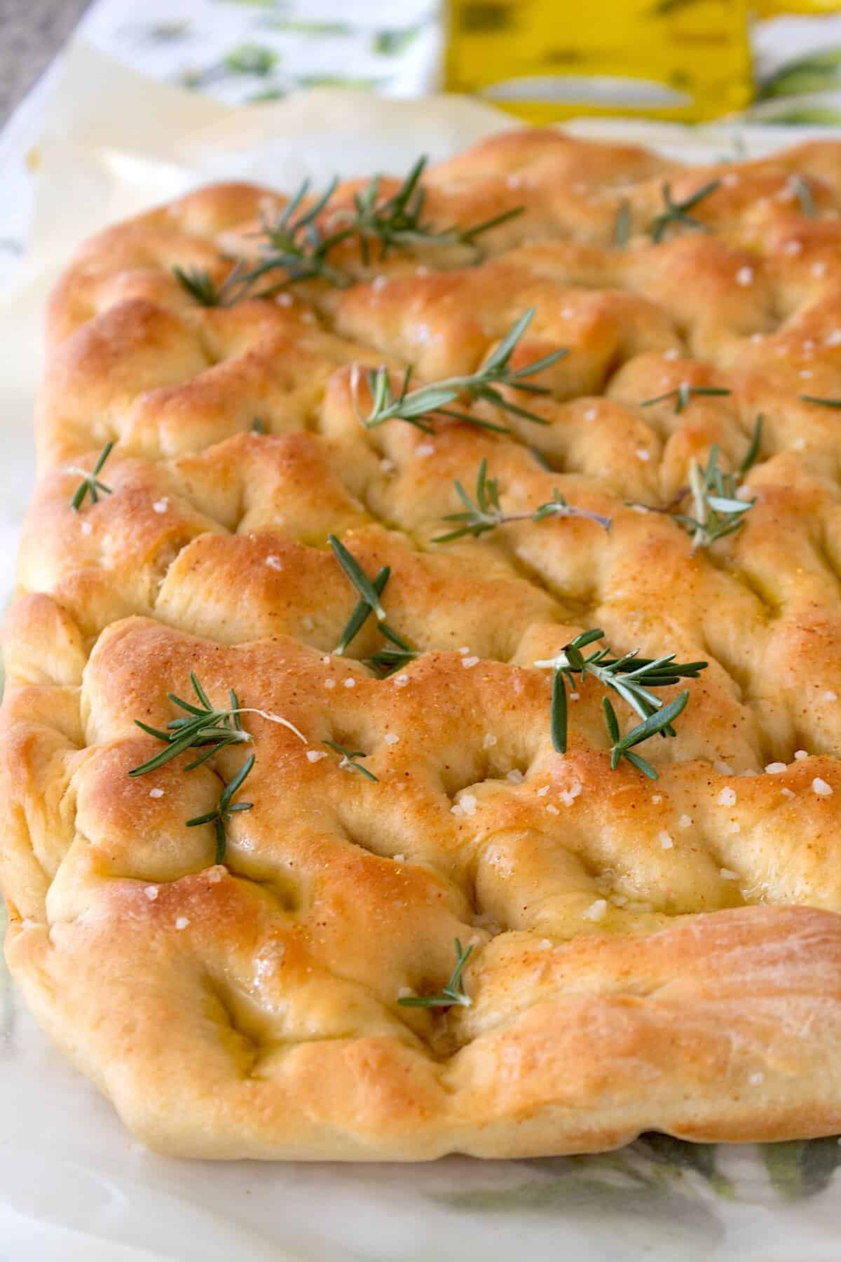 loaf of focaccia bread on parchment paper