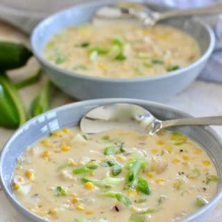 chicken and corn chowder in a gray bowl with spoon