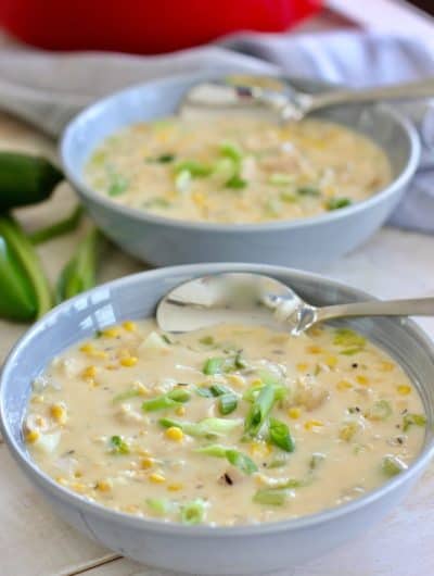 chicken and corn chowder in a gray bowl with spoon