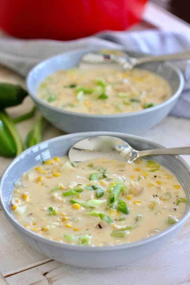 chicken and corn chowder in a gray bowl with spoon