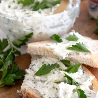 homemade Boursin cheese spread on a sourdough slice with parsley garnish