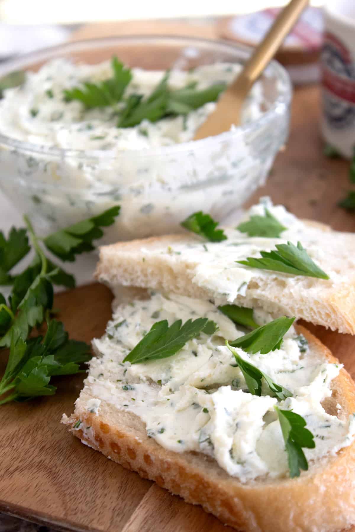 homemade Boursin cheese spread on a sourdough slice with parsley garnish