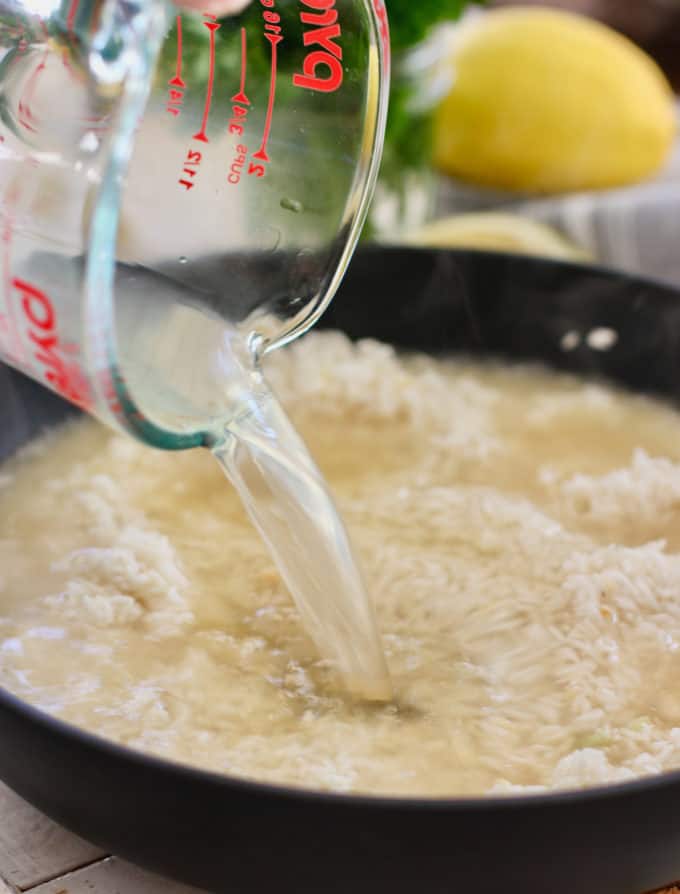 Add chicken stock to the rice and cook