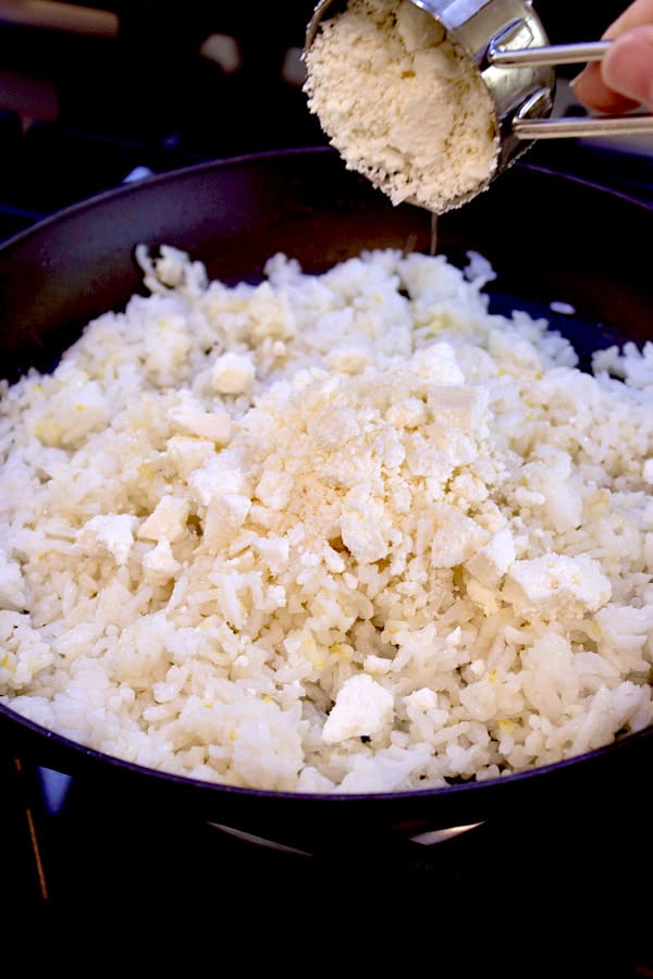 adding feta cheese to greek rice skillet