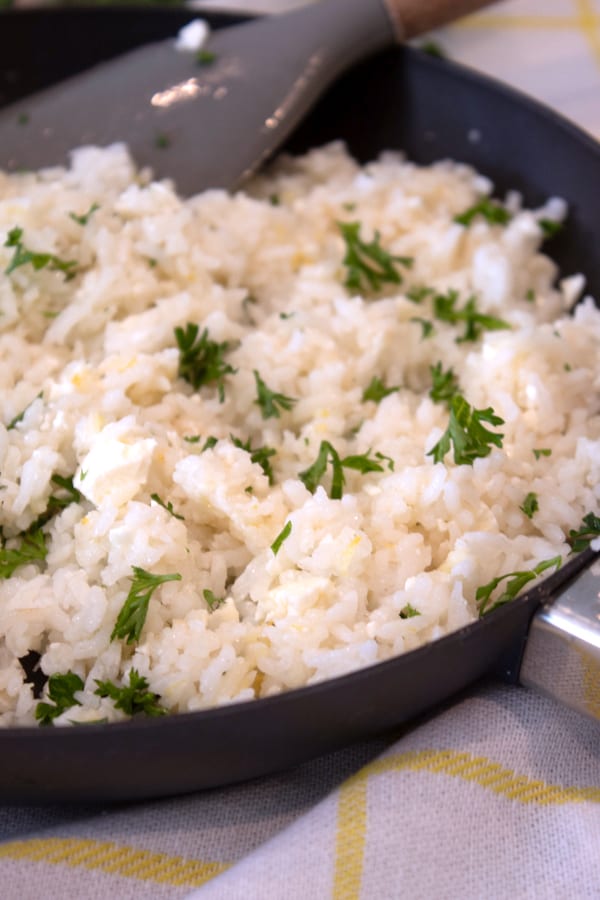 adding parsley to greek rice skillet