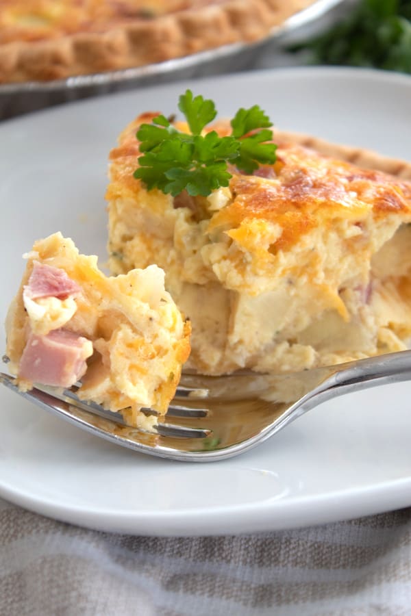 a slice of quiche with a fork bite taken out