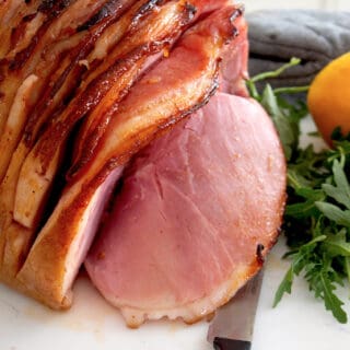 honey baked ham on a cutting board
