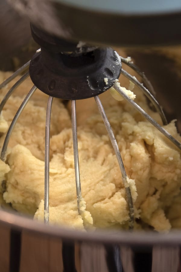 mixing white cookie dough in a stand mixer