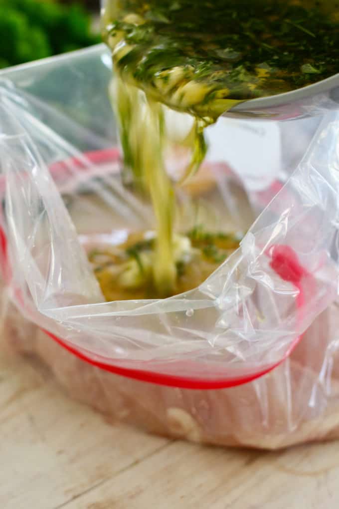 pour marinade over chicken and zip top bag