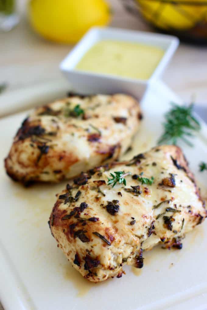 grilled marinated greek chicken on a cutting board
