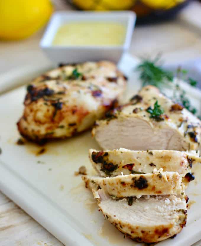 Greek Marinated chicken sliced on a board