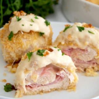 Baked chicken cordon bleu cut in half with dijon sauce on top