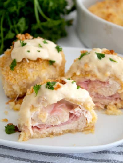 Baked chicken cordon bleu cut in half with dijon sauce on top