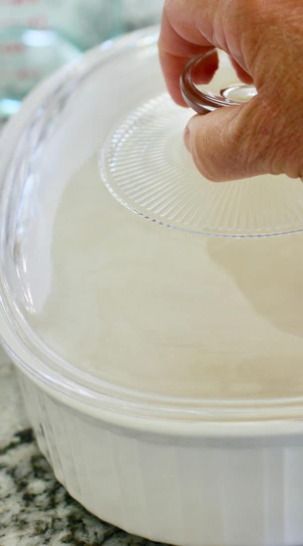 putting lid onto baking dish to bake rice