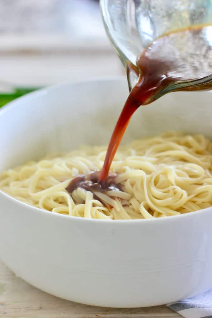 pour dressing over hot noodles