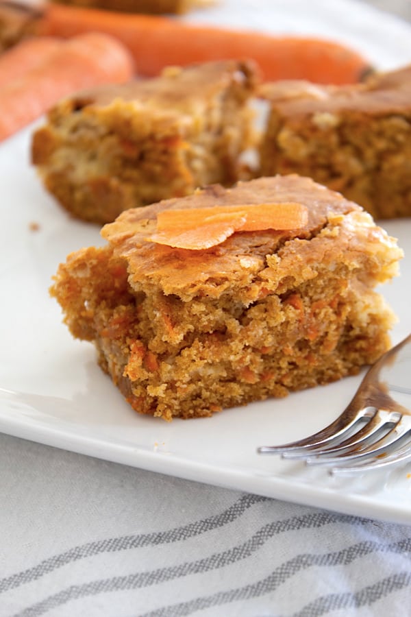 carrot cake bars garnished with carrot slices