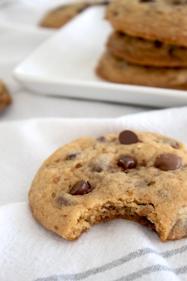 bite out of a chocolate chip cookie on a white towel