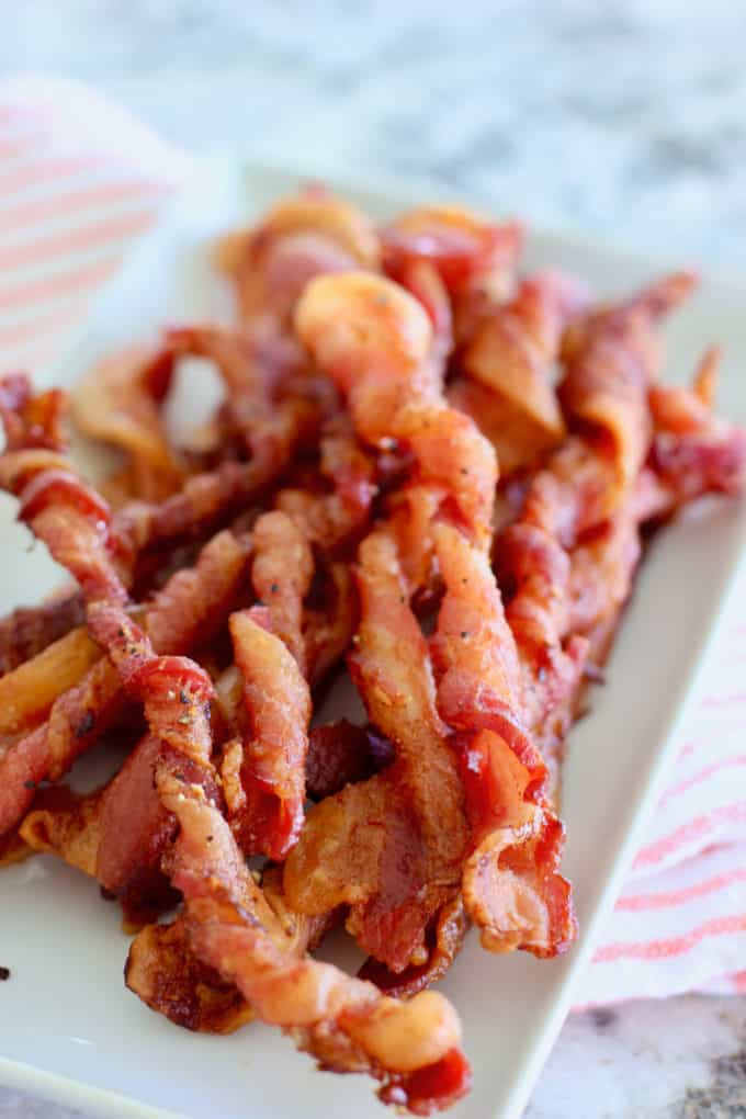 oven baked twisted bacon on a white dish